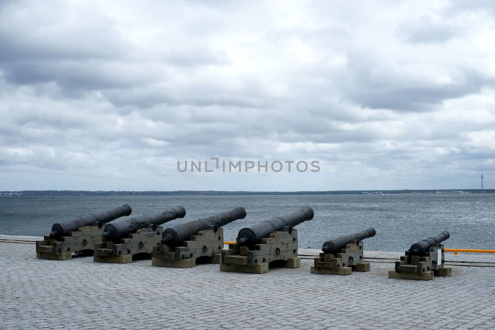 Old guns are on coast on a background of the sea