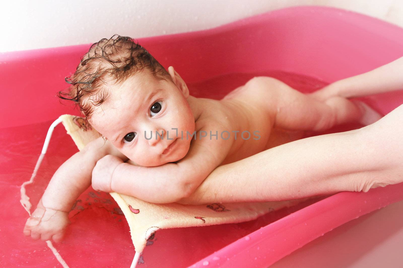 Pretty girl is having a bath in her bathtub