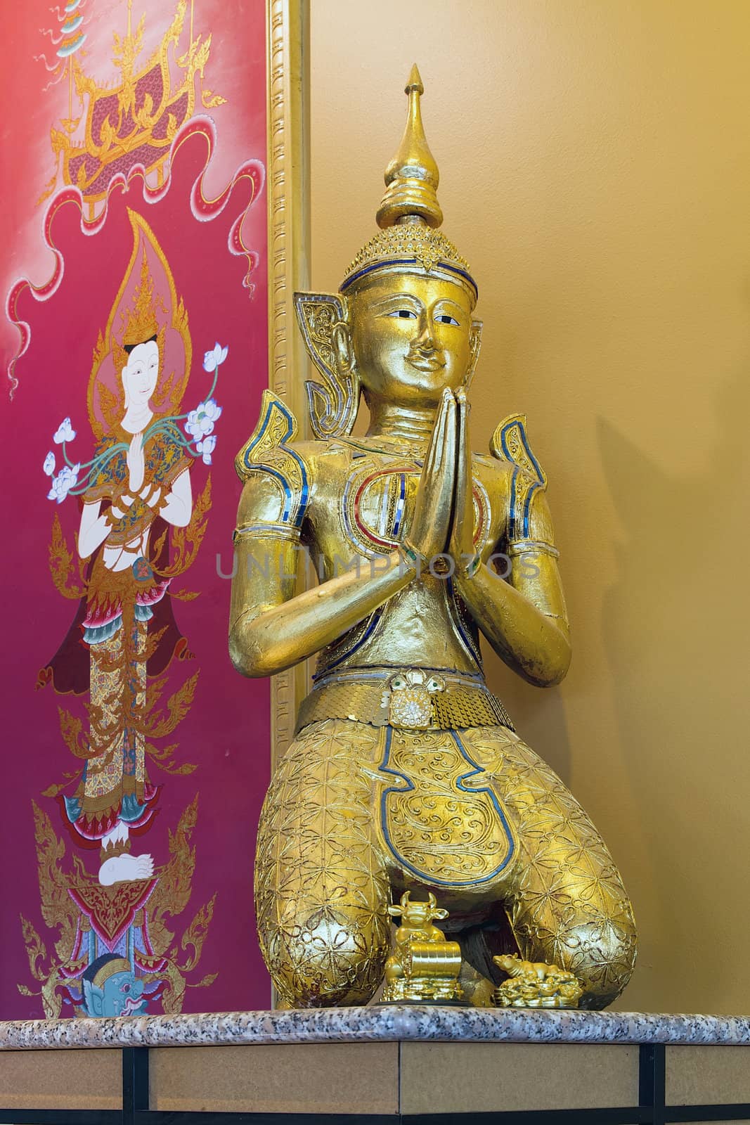 Thai Teppanom Angel Statue and Goddess Painting in Background