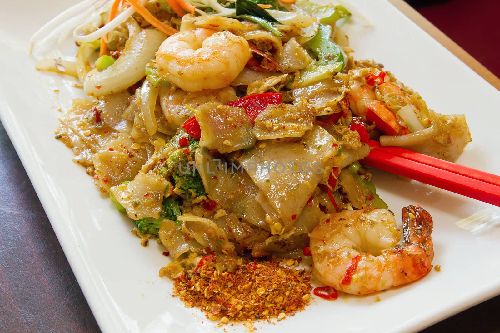 Thai Pad Kee Mao Rice Noodle with Prawns and Vegetable Dish And Side of Spicy Chili Powder