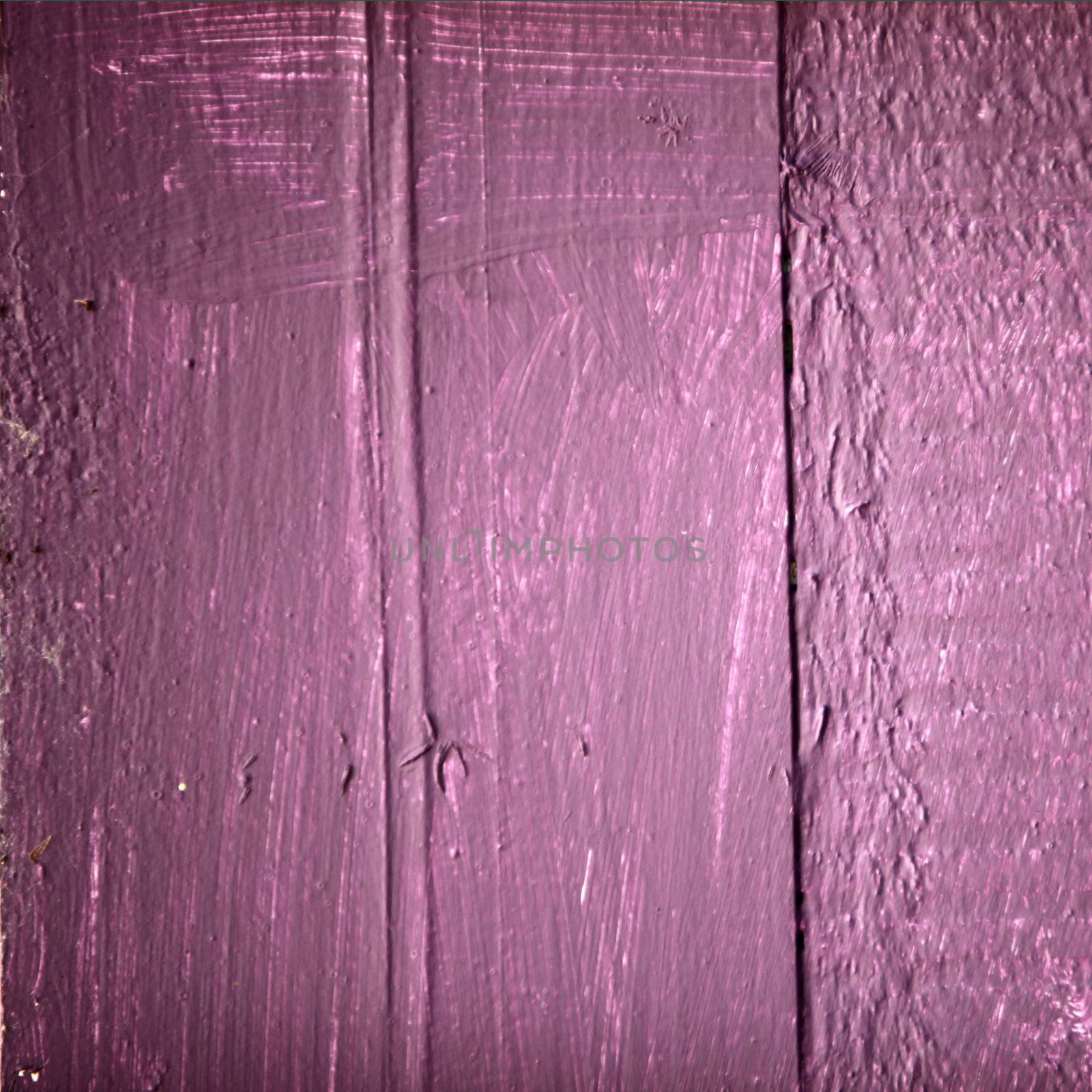 Purple painted wood texture over a pink base with rough woodgrain surface detail on wooden planks