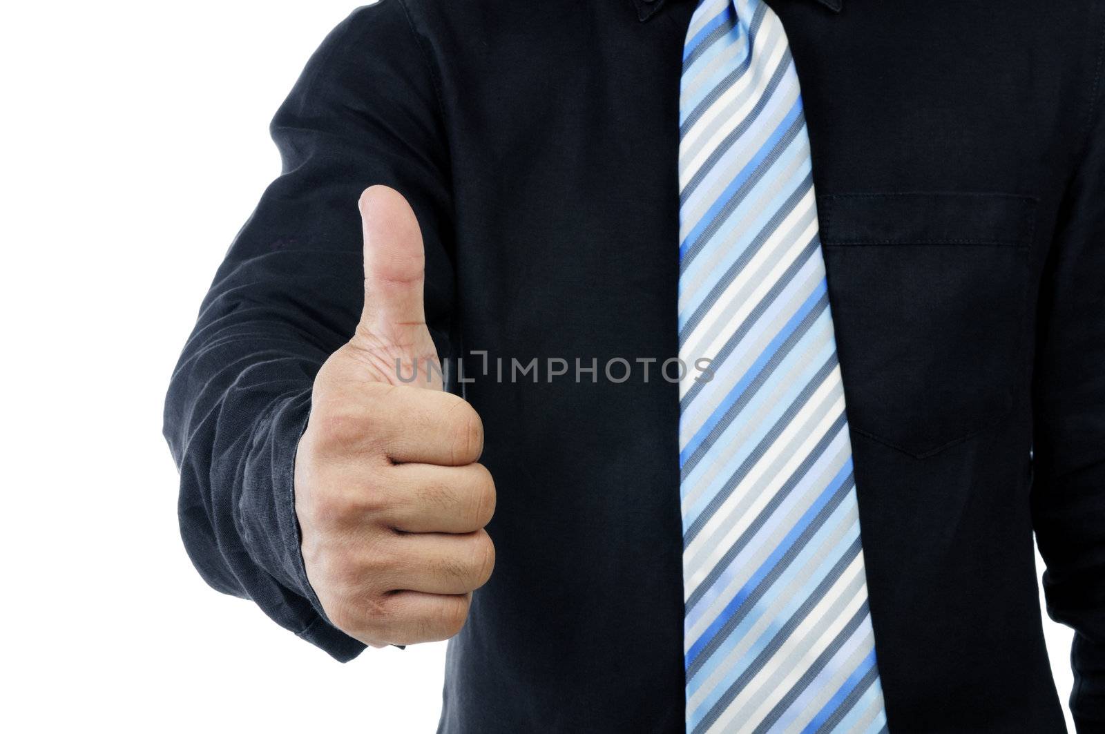Closeup of a businessman giving thumb up sign against white background.
