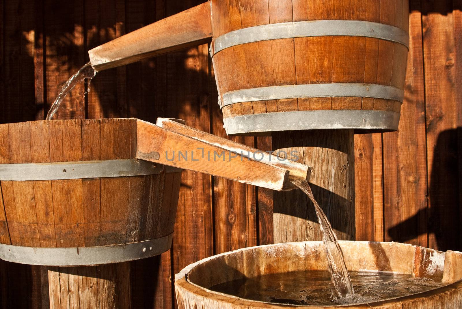 Wooden water barrels funnel water through shutes