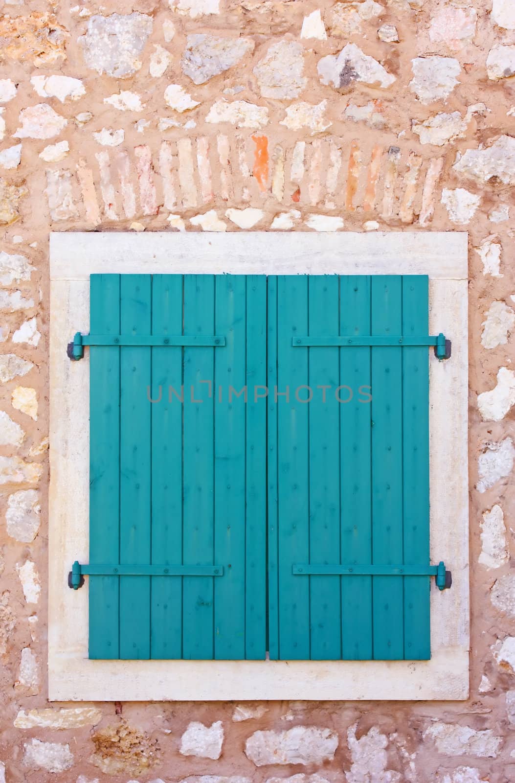Closed green wooden window shutters, security element