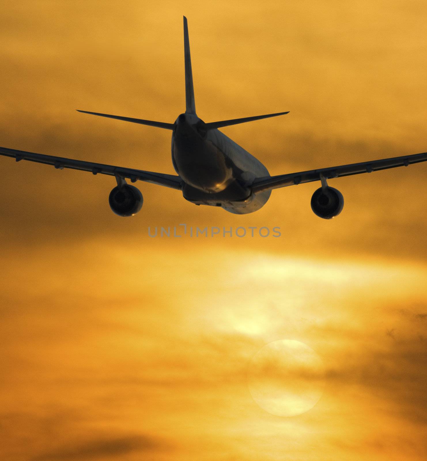 Airplane Flying Towards The Sunset With Passengers Going On Vacation