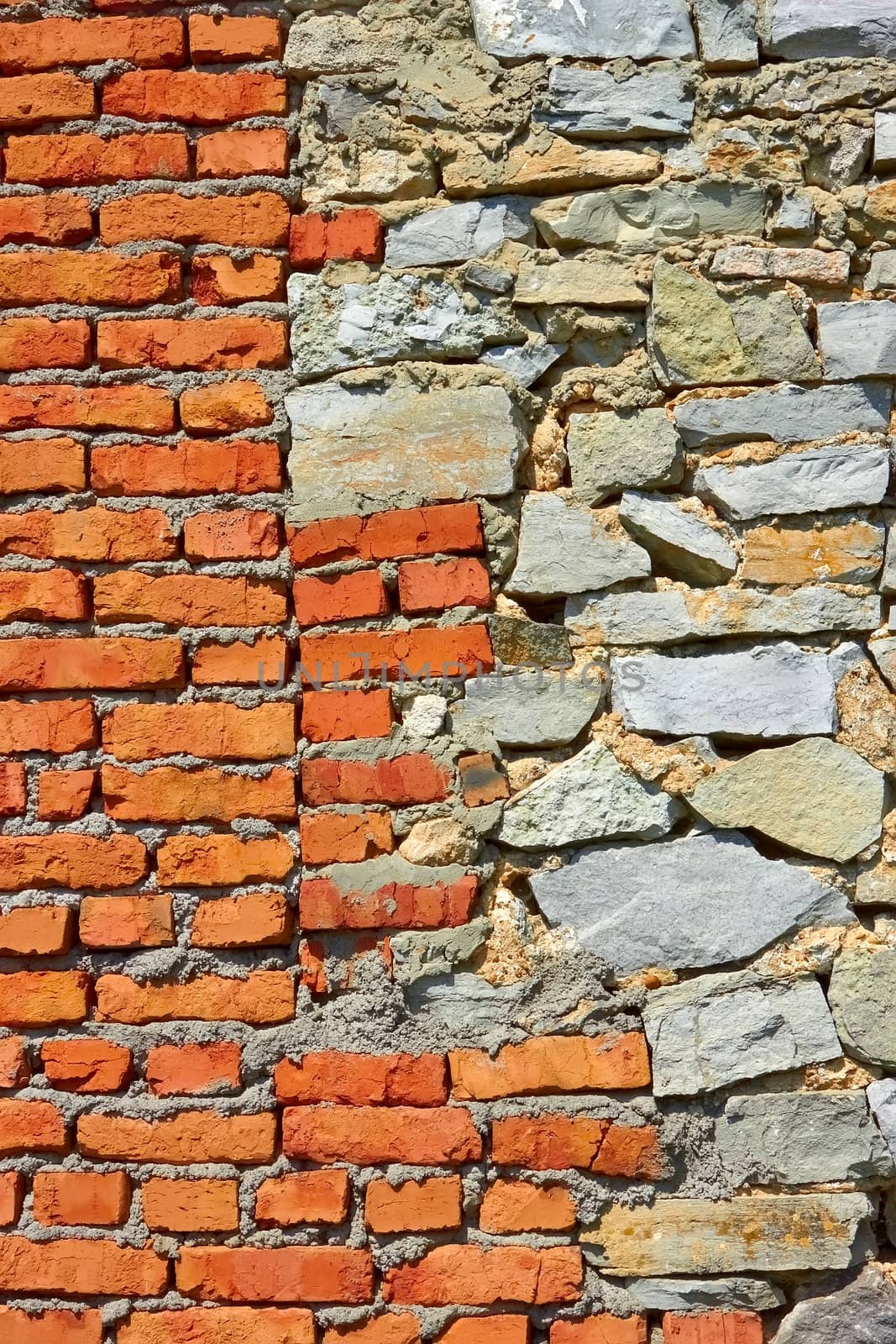 Wall partially from formless stone and red brick