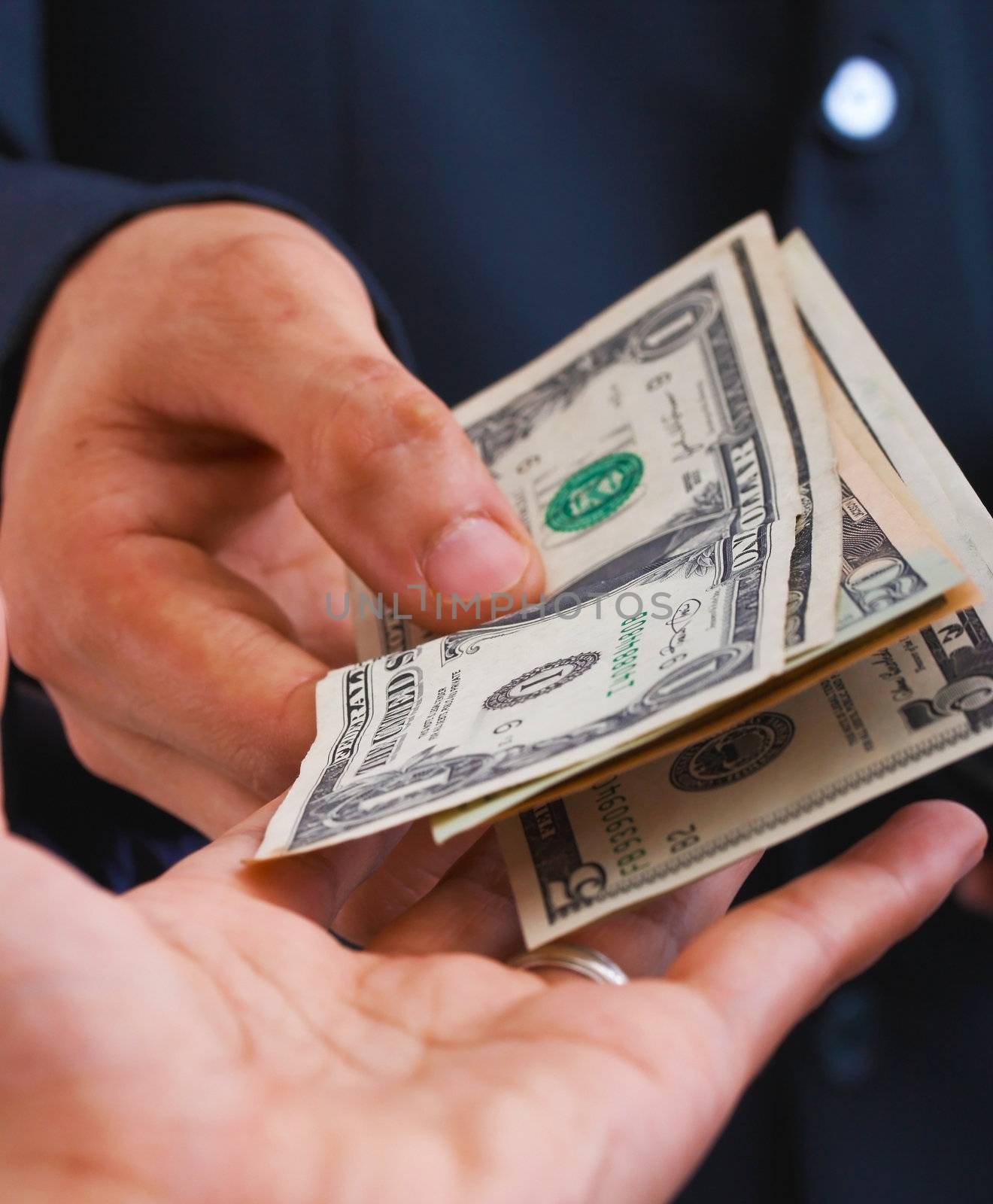 Man Receiving Dollars From Another Man As Payment For A Sale
