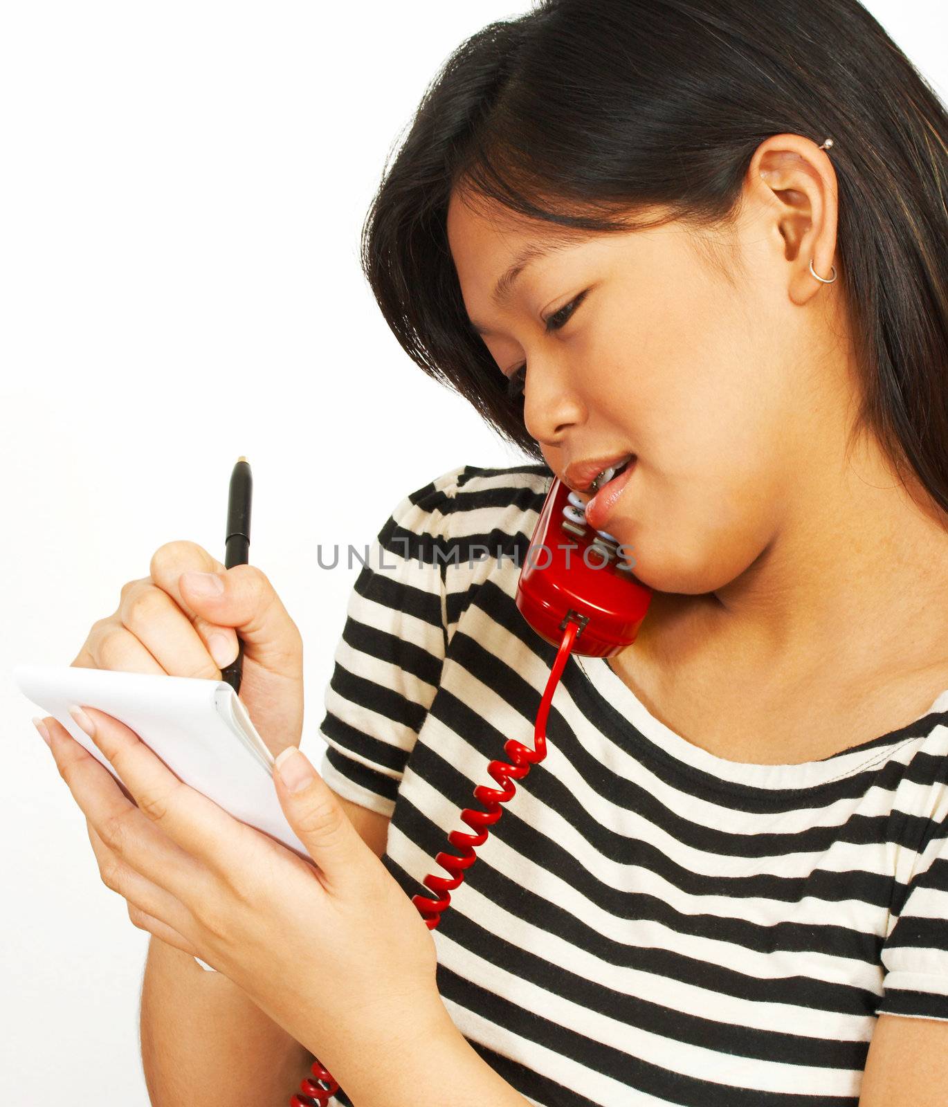 A Woman Talking To Someone And Taking Notes On A Notepad