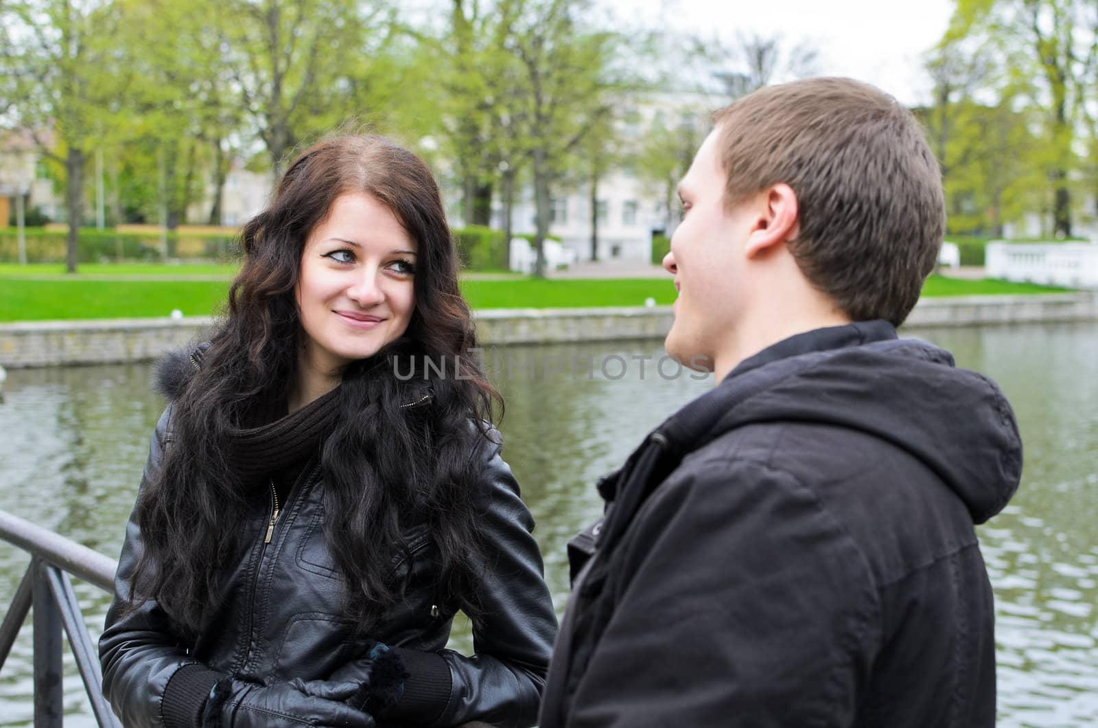 Girl and guy near the pond in the park by dmitrimaruta