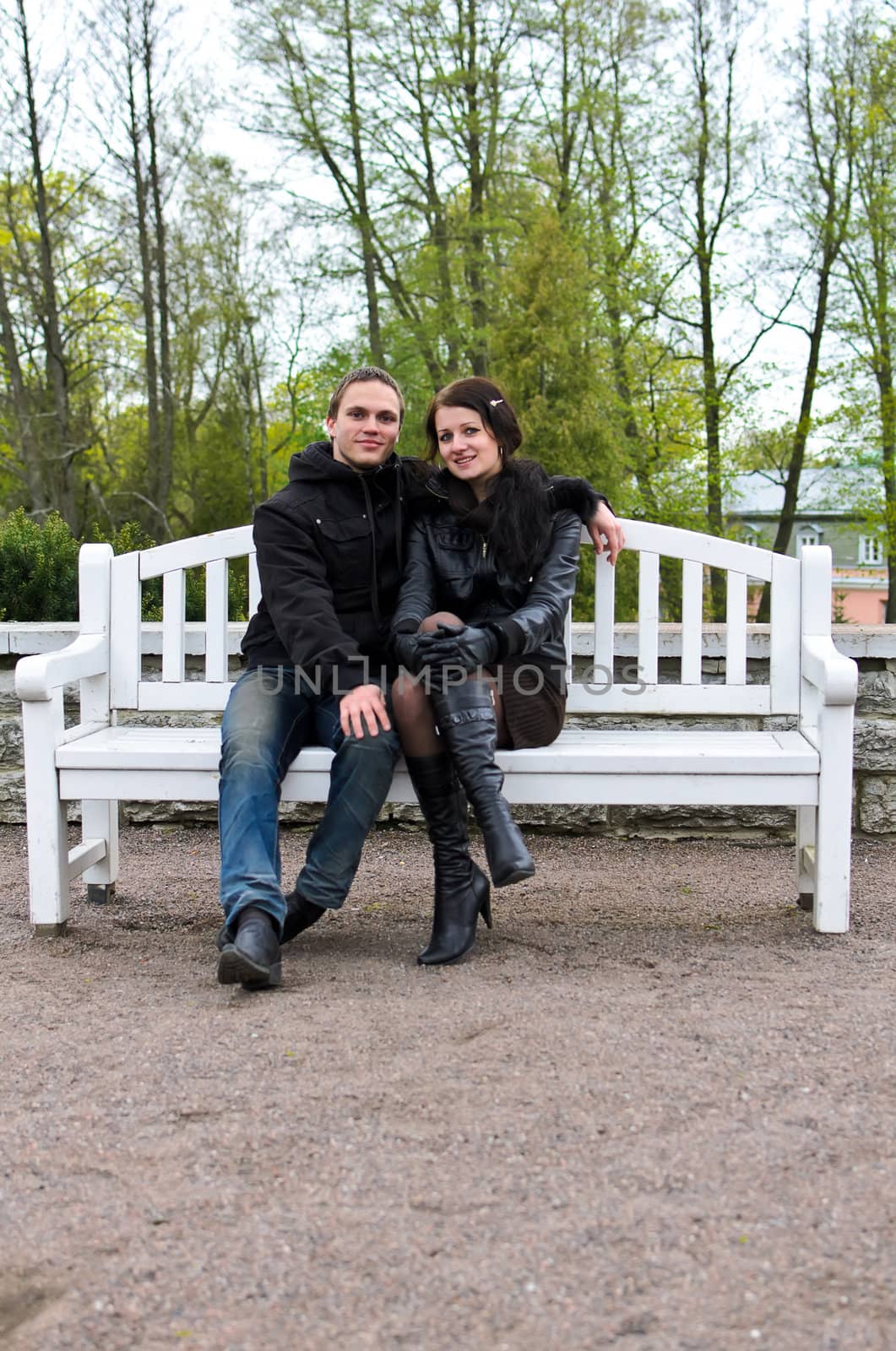 Portrait of happy couple on park bench.