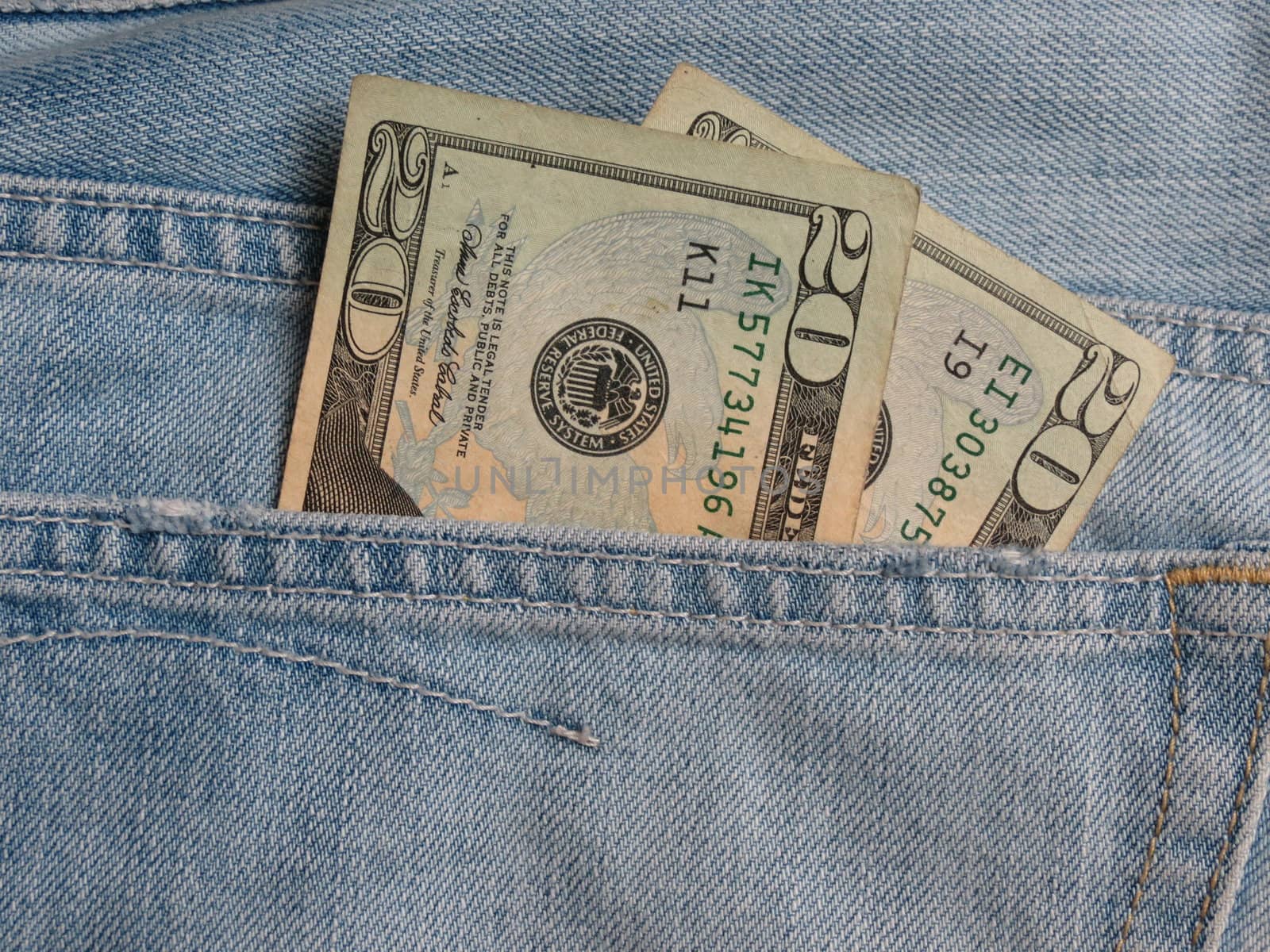 USD notes in blue jeans pocket by paolo77