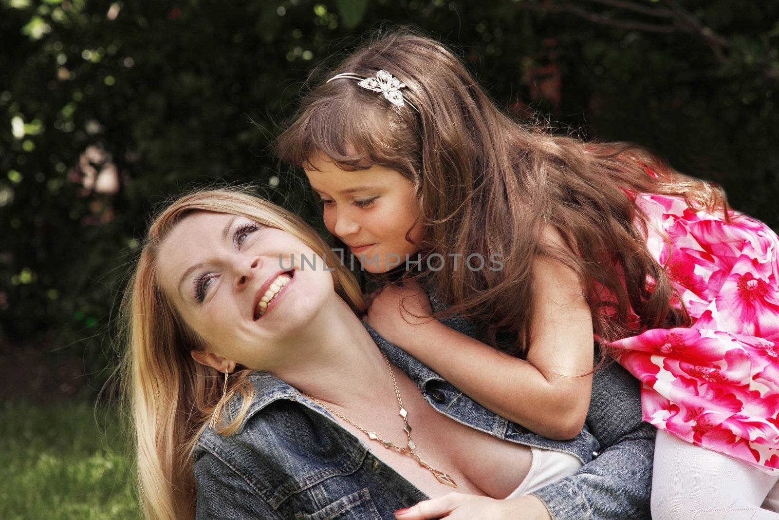 Portrait of beautiful happy smiling mather with daughter outdoor, on nature