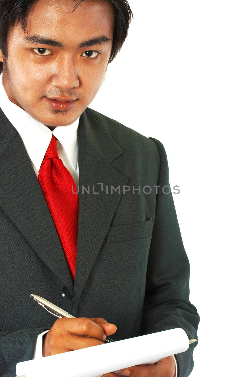 Businessman In Suit And Tie Writing A Note Or Memo
