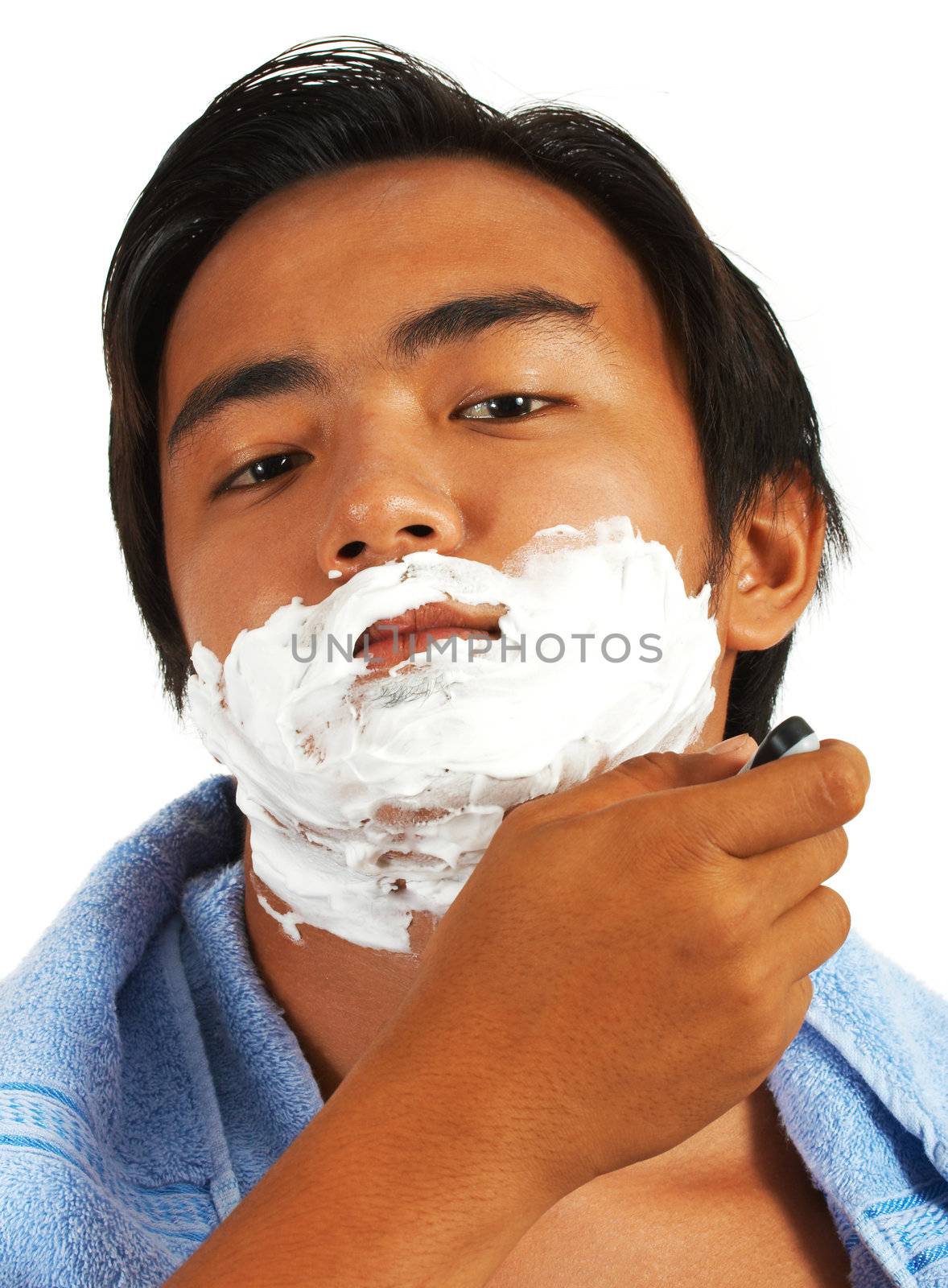 Young Man Shaving To Remove His Stubble