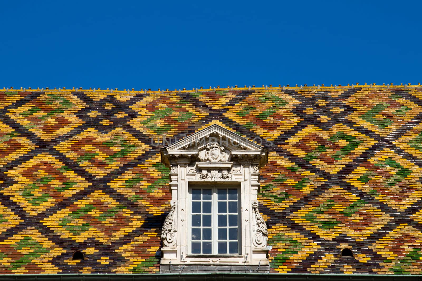 A Colored roof tile against blue sky