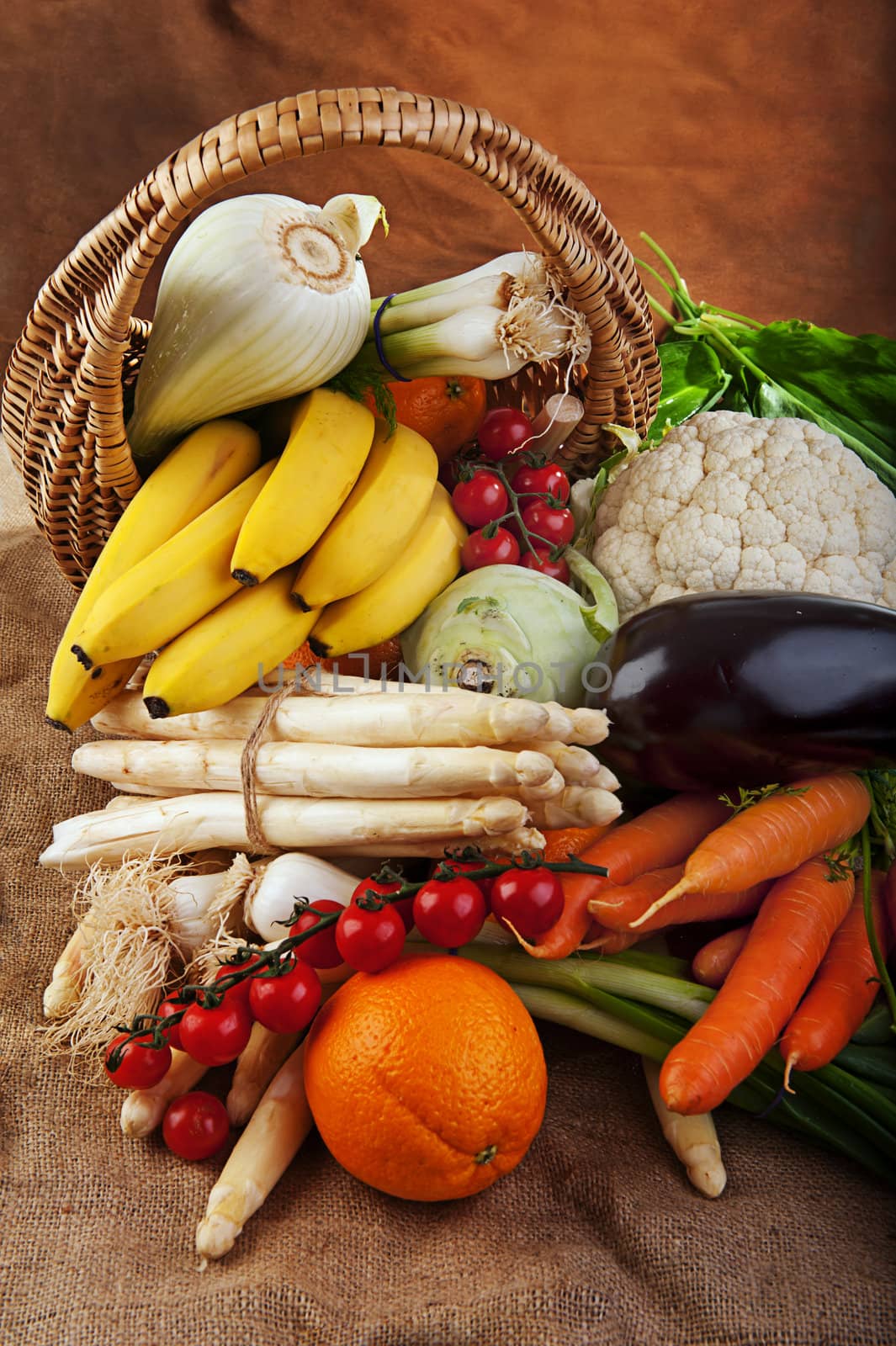 Basket full of various fresh organic vegetables and fruits from the garden