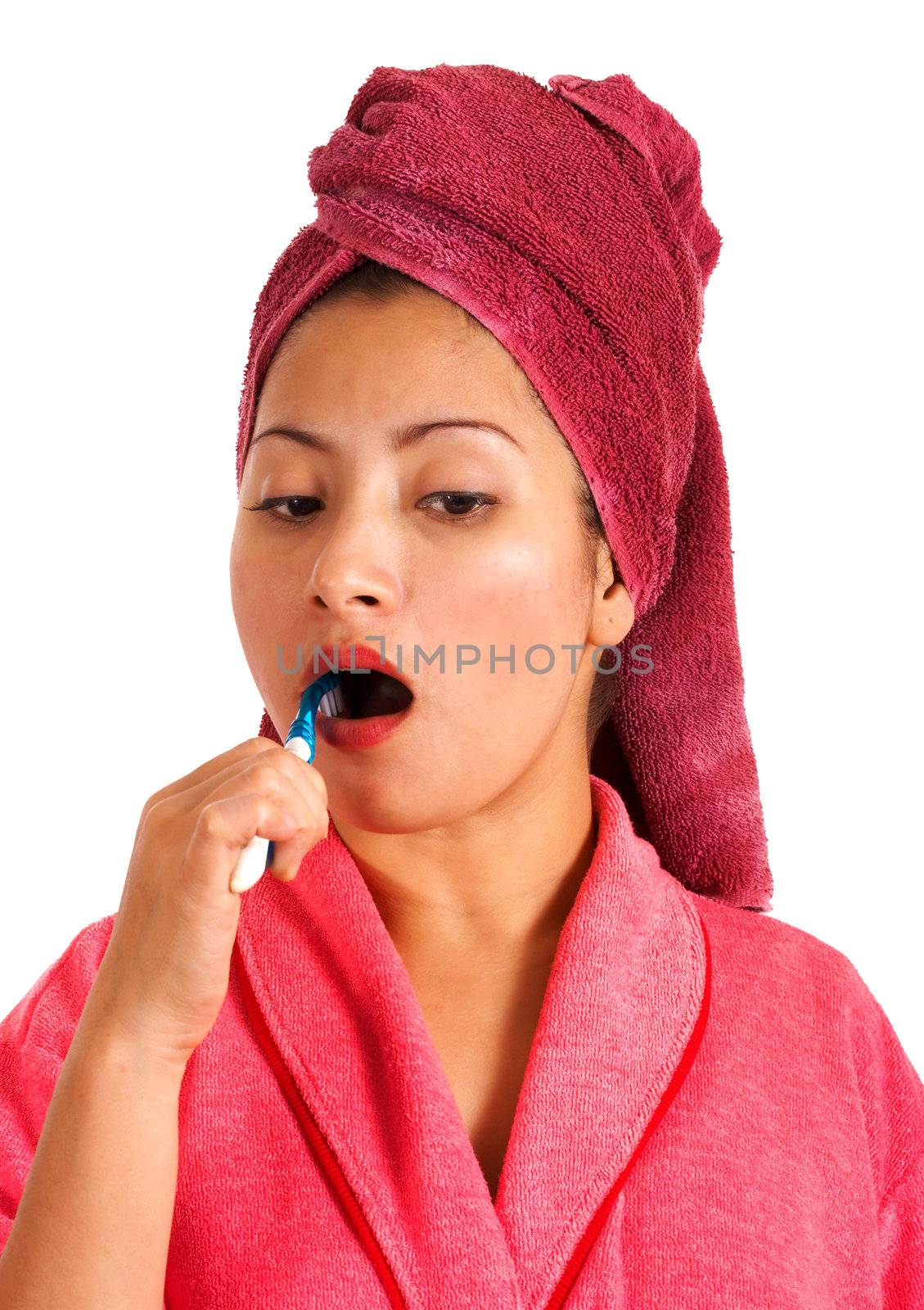Woman In Bathrobe And Towel Brushing Her Teeth