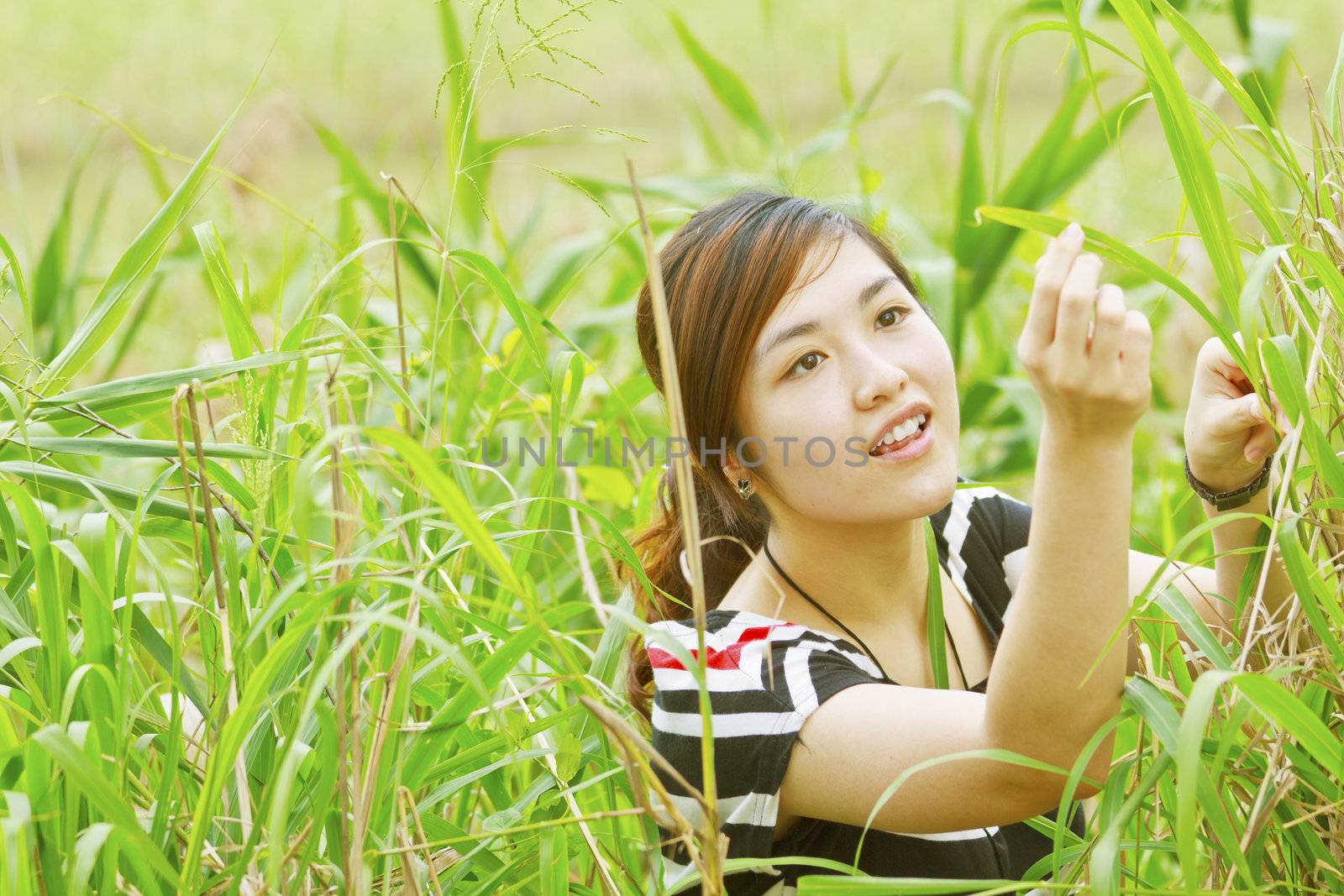 Summer girl portrait. Asian woman smiling happy on sunny summer.