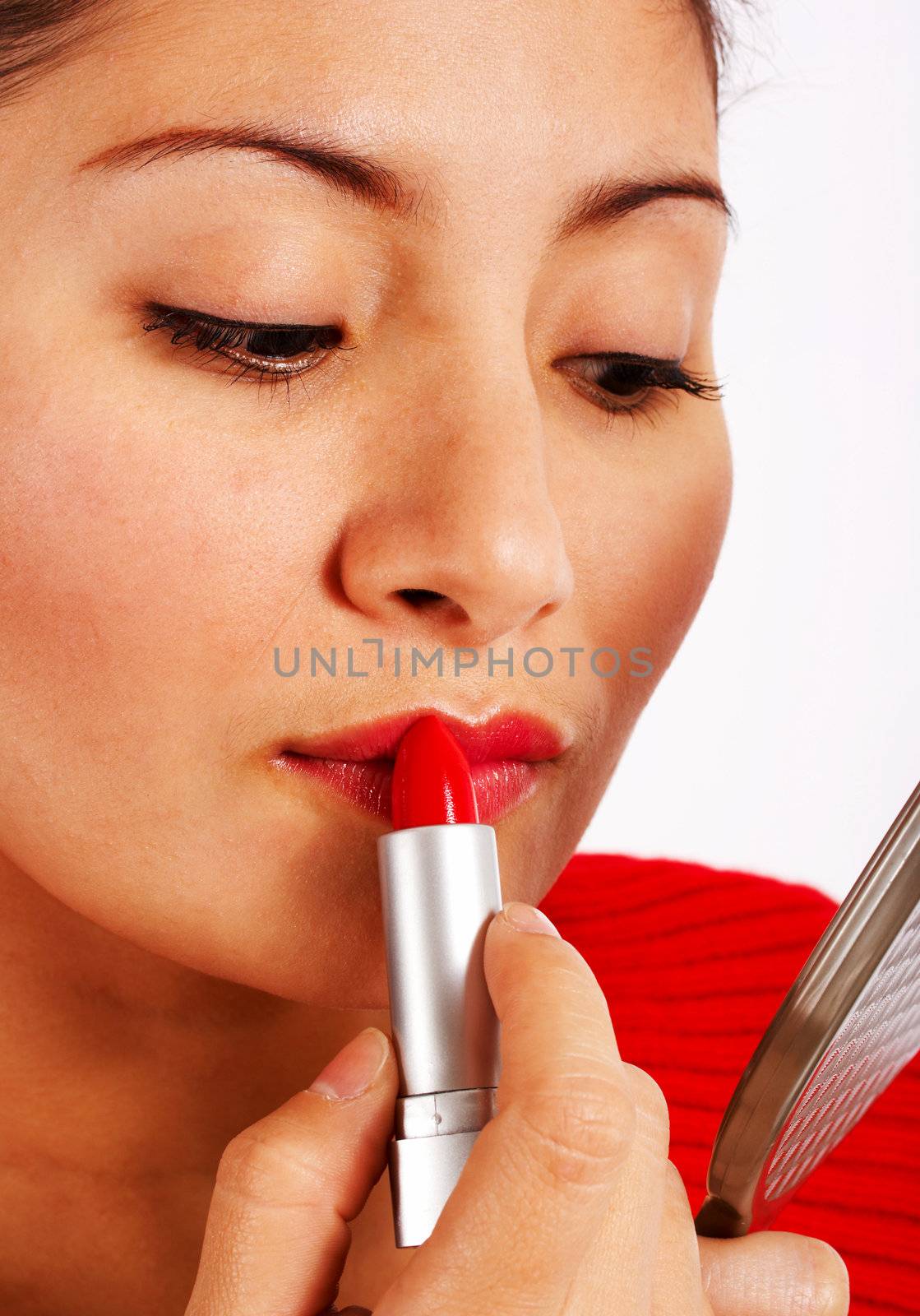 Woman Applying Red Lipstick by stuartmiles