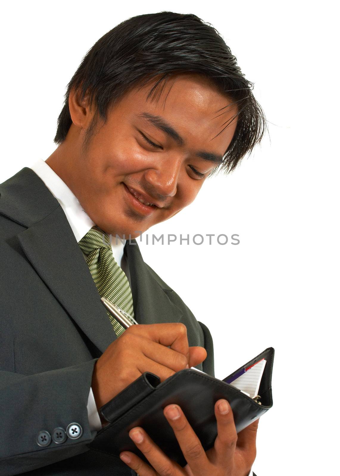 Businessman Writing His Schedule In His Organizer