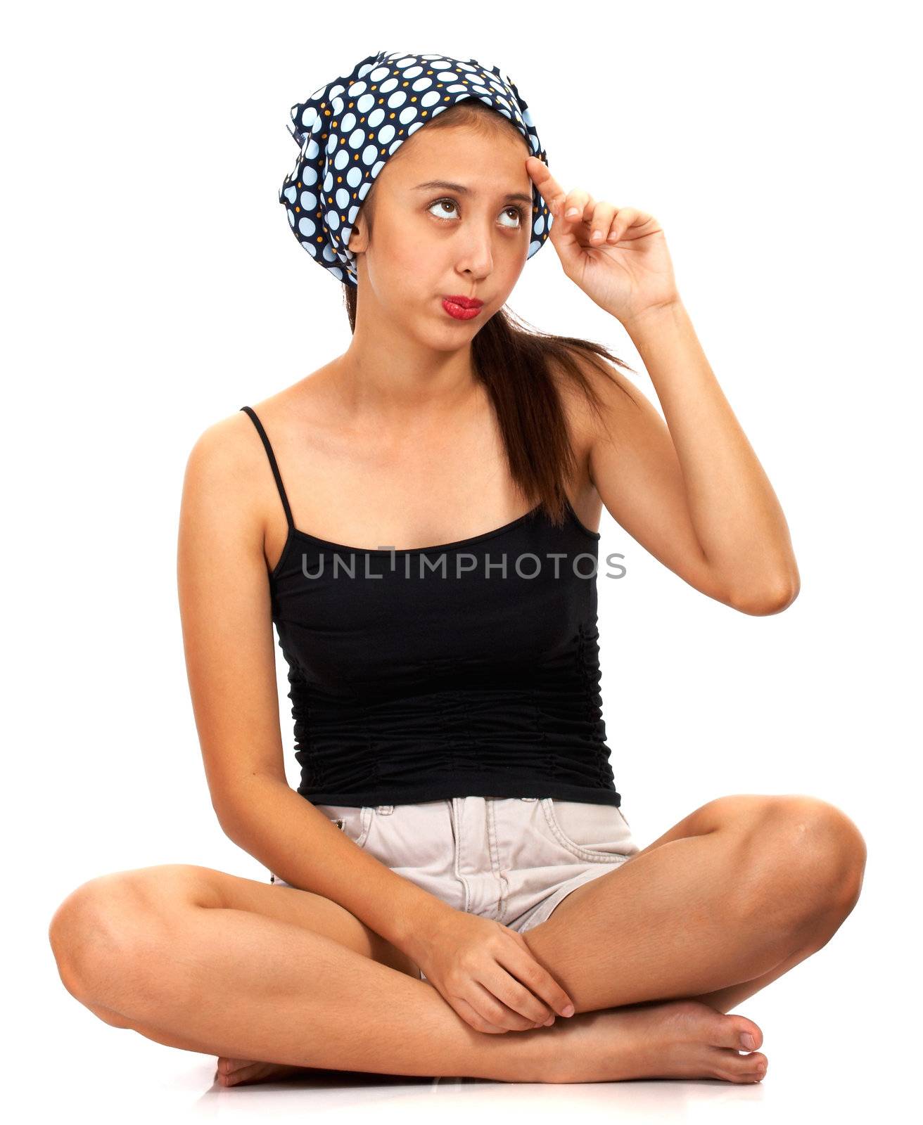 Young Girl Thinking About Something And Sitting Cross Legged