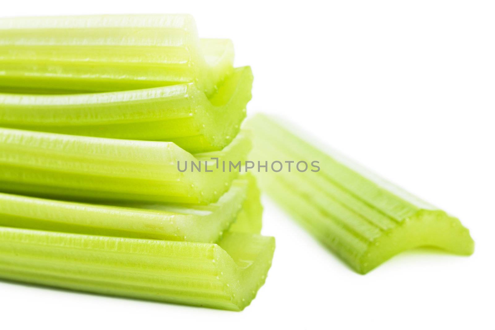 Fresh green stems of celery over white background