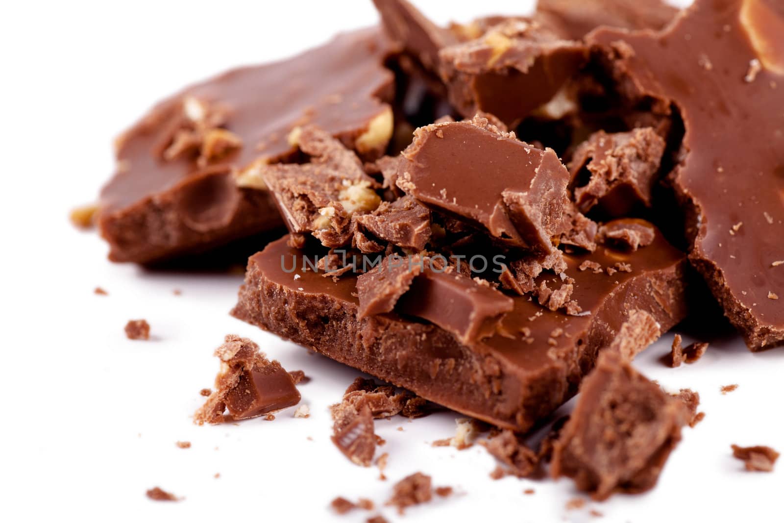 Close-up view of pieces of chocolate over white background