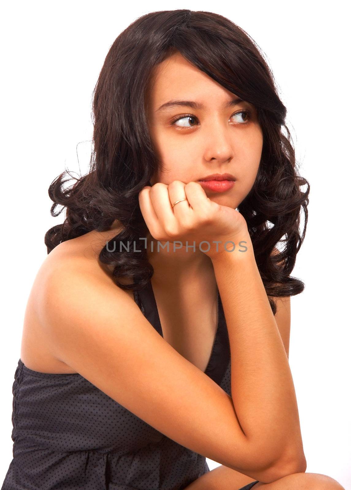 Lonely Girl Sitting Down With A Thoughtful Expression