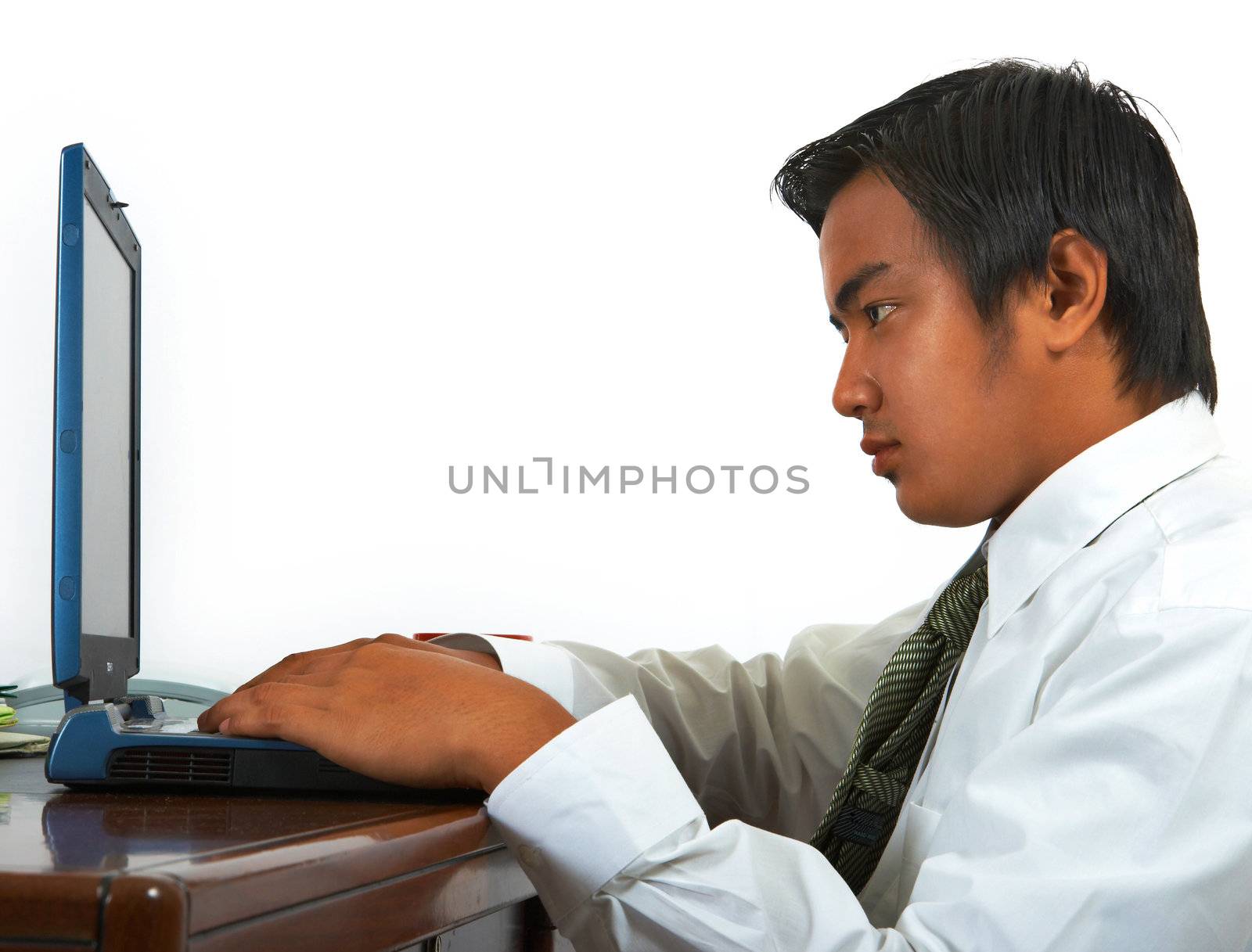 Man In His Office Working On His Computer by stuartmiles