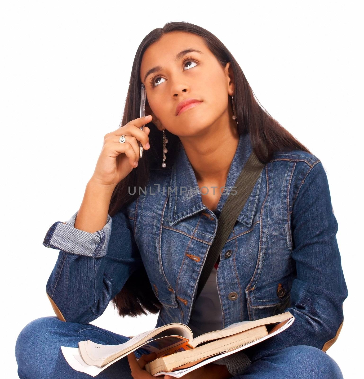 Young Student Holding Books And Looking In The Air Thinking About Her Studies