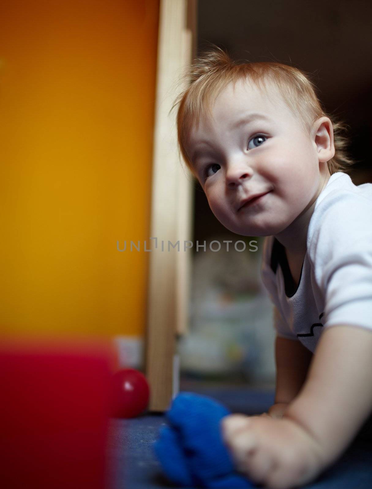 Little handsome boy playing in his room.