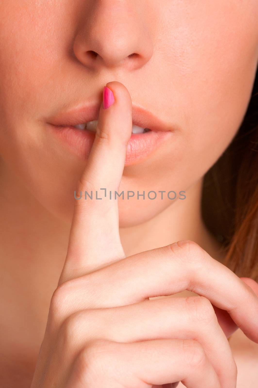 Young girl with her finger over her mouth