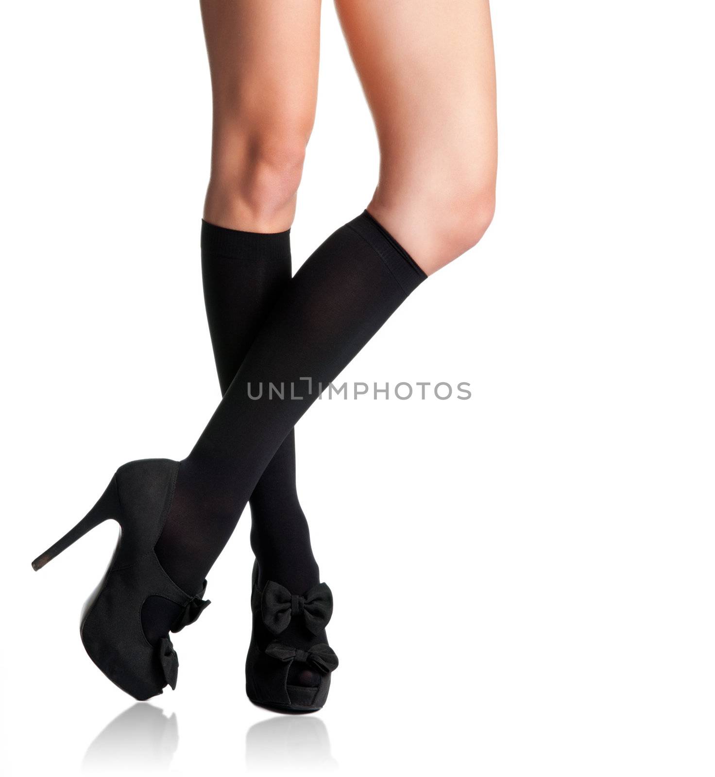 Businesswoman s legs in high stockings and high heels in a white background