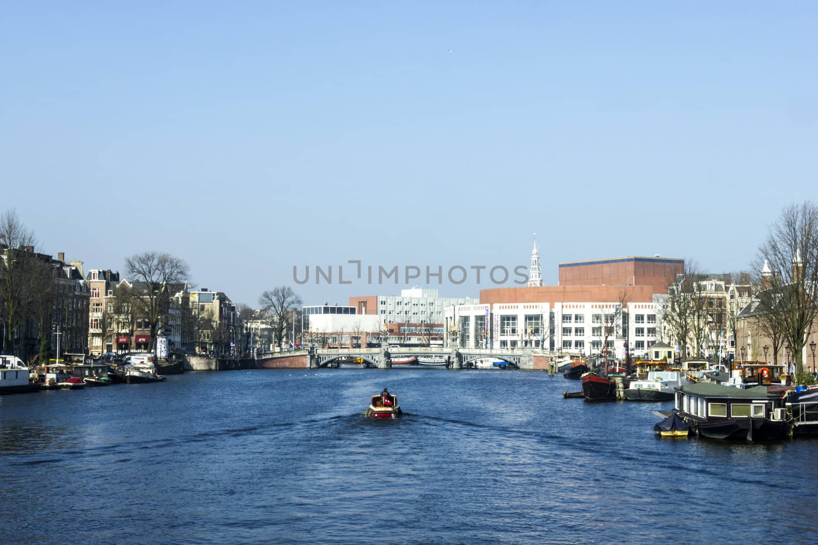Amsterdam city in the Netherlans, boat in the river Amstel