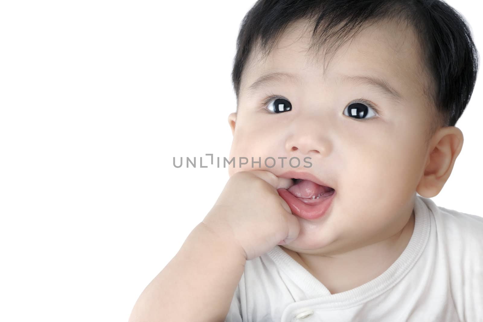 Close-up portrait of an adorable infant baby putting finger in his mouth, isolated on white.