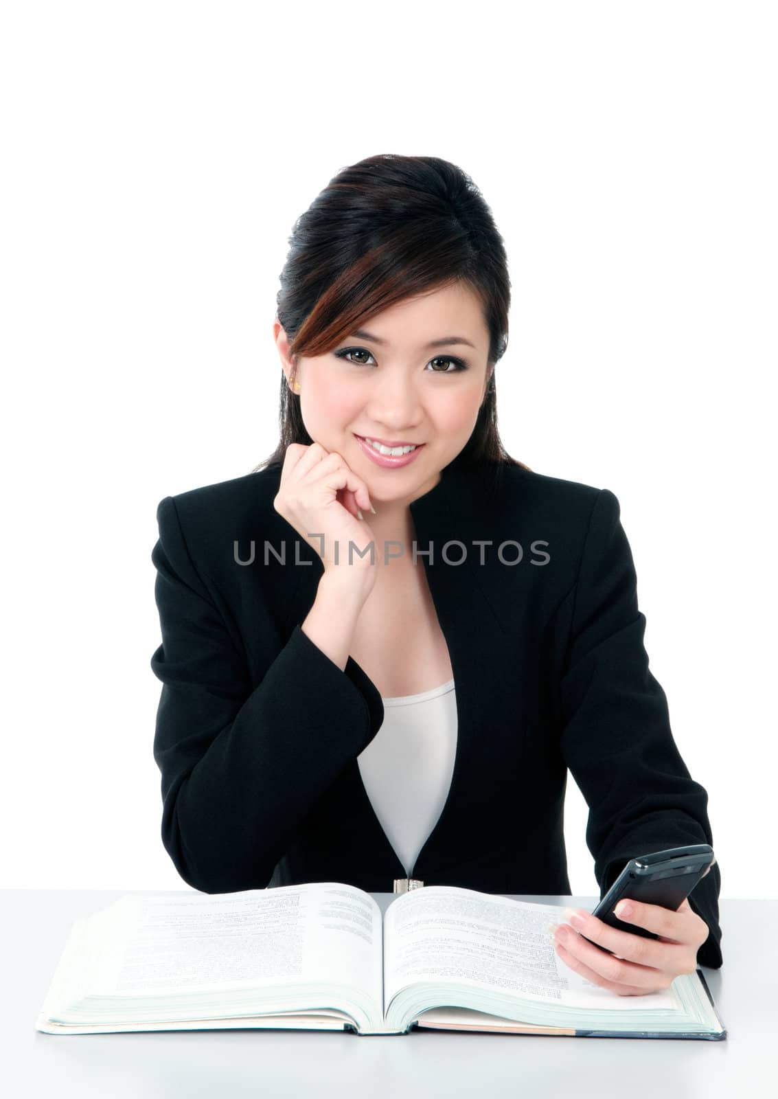 Portrait of a beautiful young businesswoman holding a mobile phone over white background.