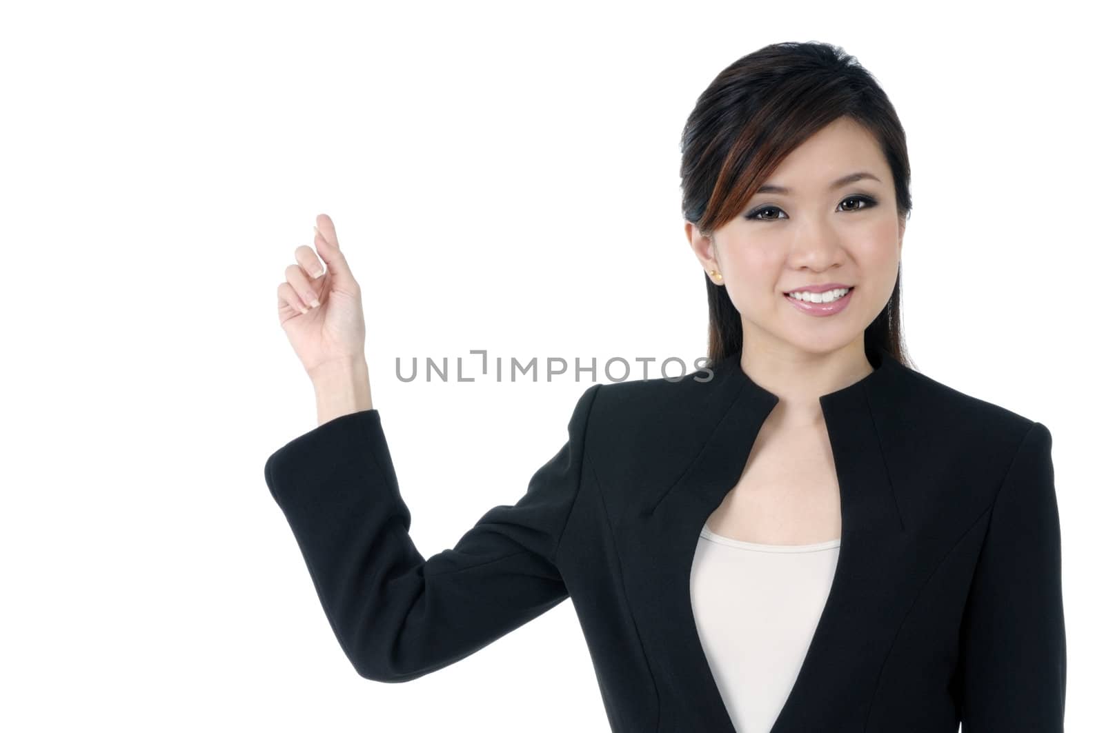 Portrait of an attractive young businesswoman pointing at copy space,  over white background.