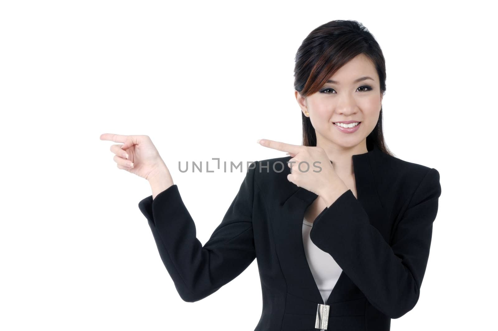 Portrait of a beautiful young Asian businesswoman pointing, isolated on white background.