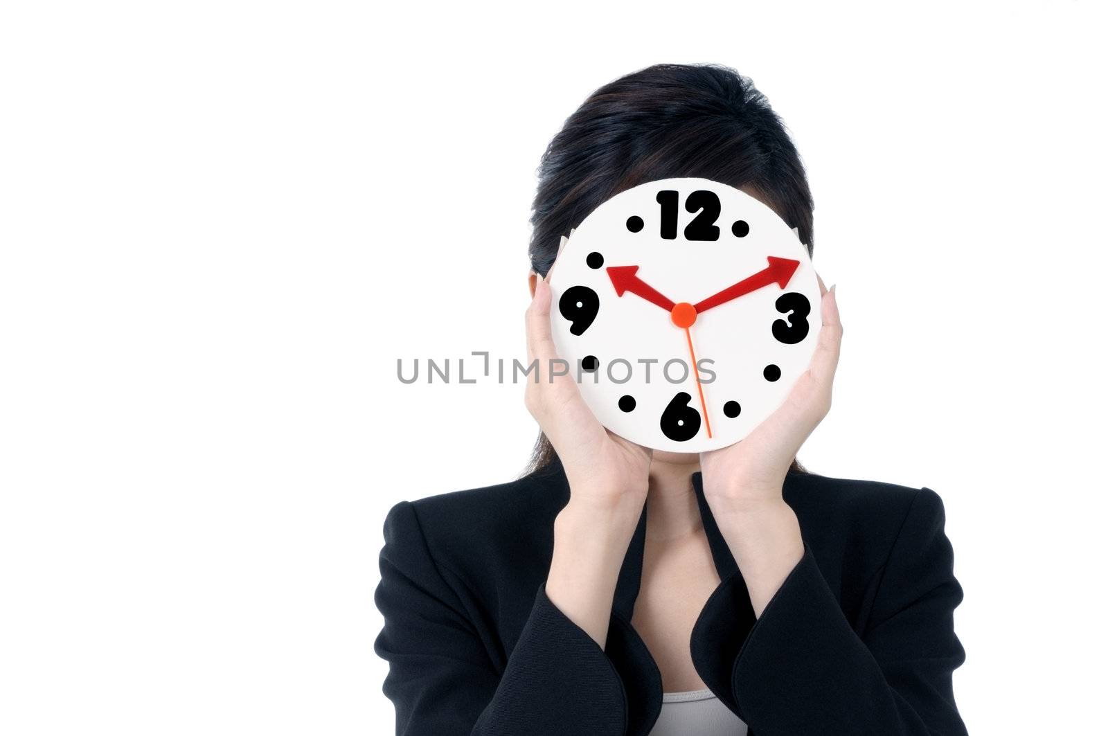 Portrait of businesswoman holding a clock over her face, isolated on white background.