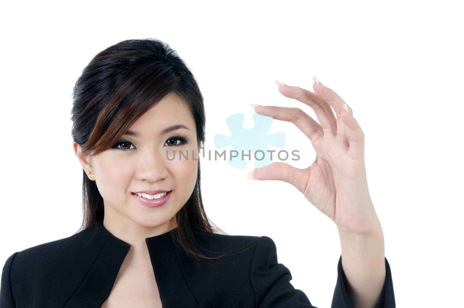 Portrait of cute young businesswoman holding a jigsaw puzzle, isolated on white background.