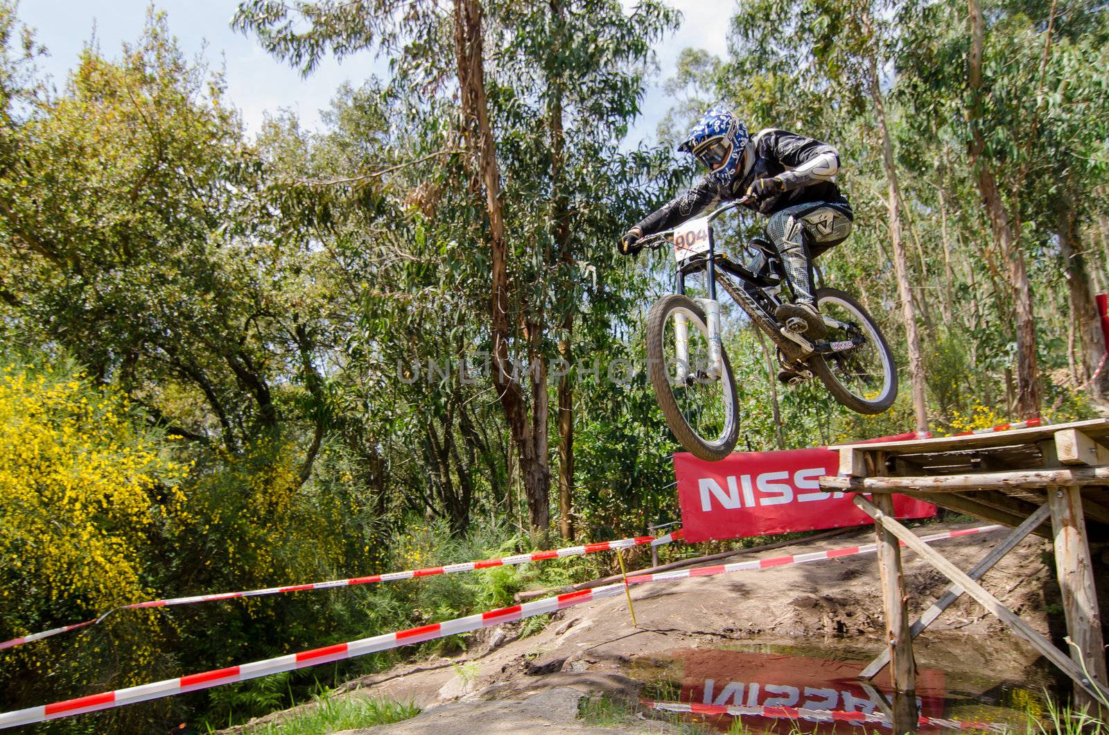 VIANA DO CASTELO, PORTUGAL - MAY 13: Nelson Costa flying over the gap on the 4th Stage of the Taca de Portugal Downhill Vodafone on may 13, 2012 in Viana do Castelo, Portugal.
