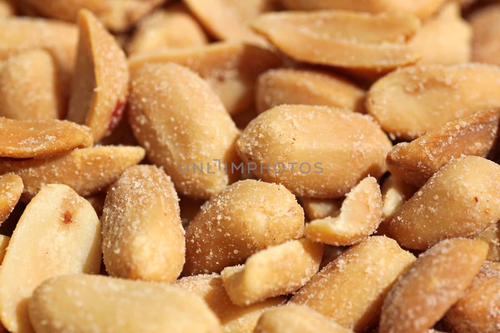 close up of heap of salted peanuts