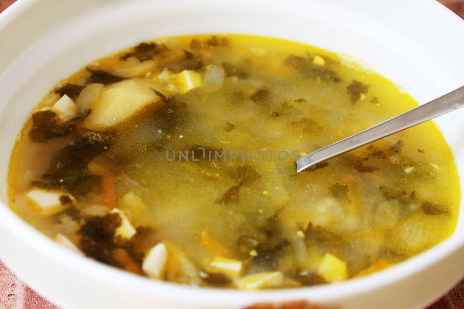 plate of soup with sorrel and eggs