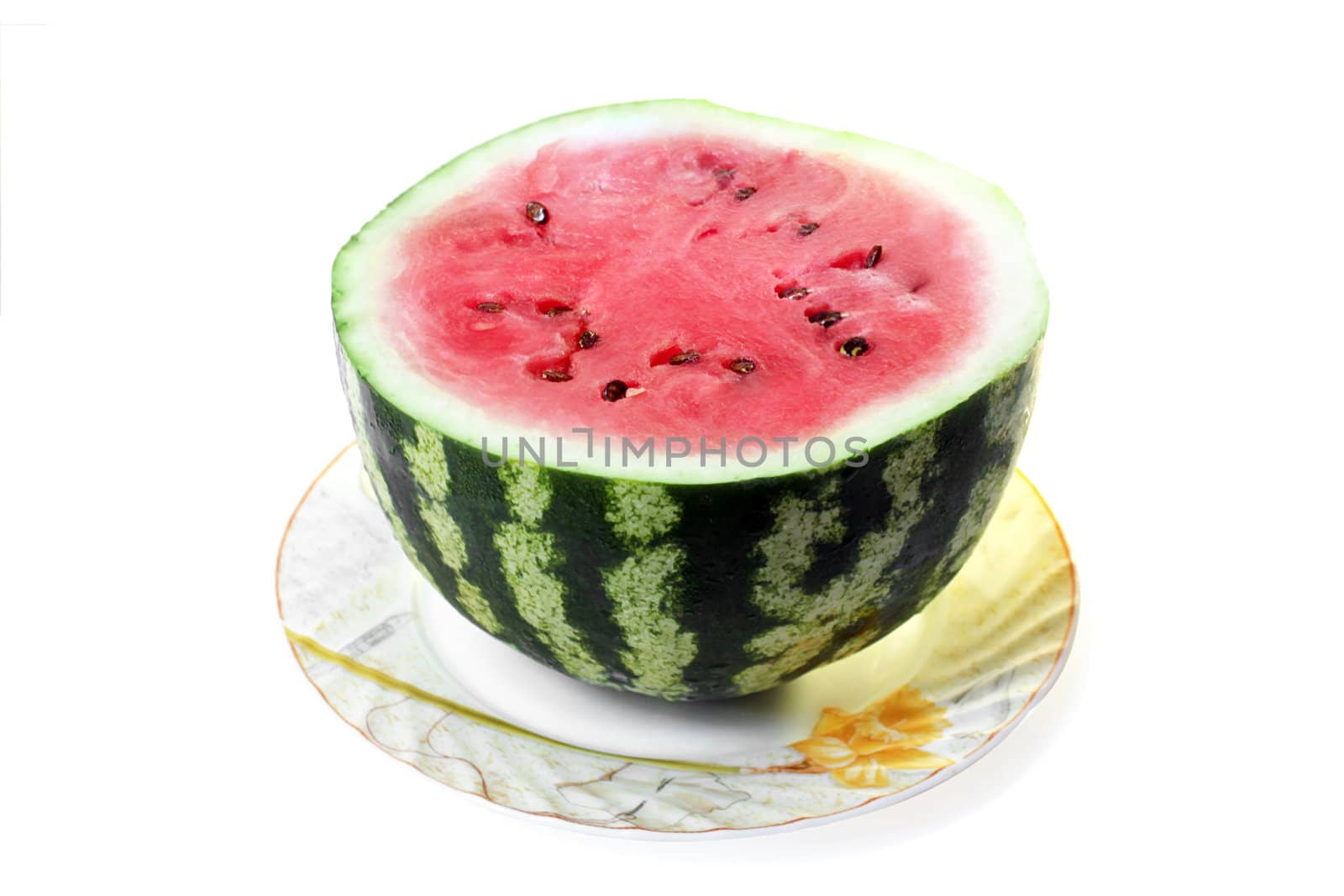 half of watermelon on a plate over white