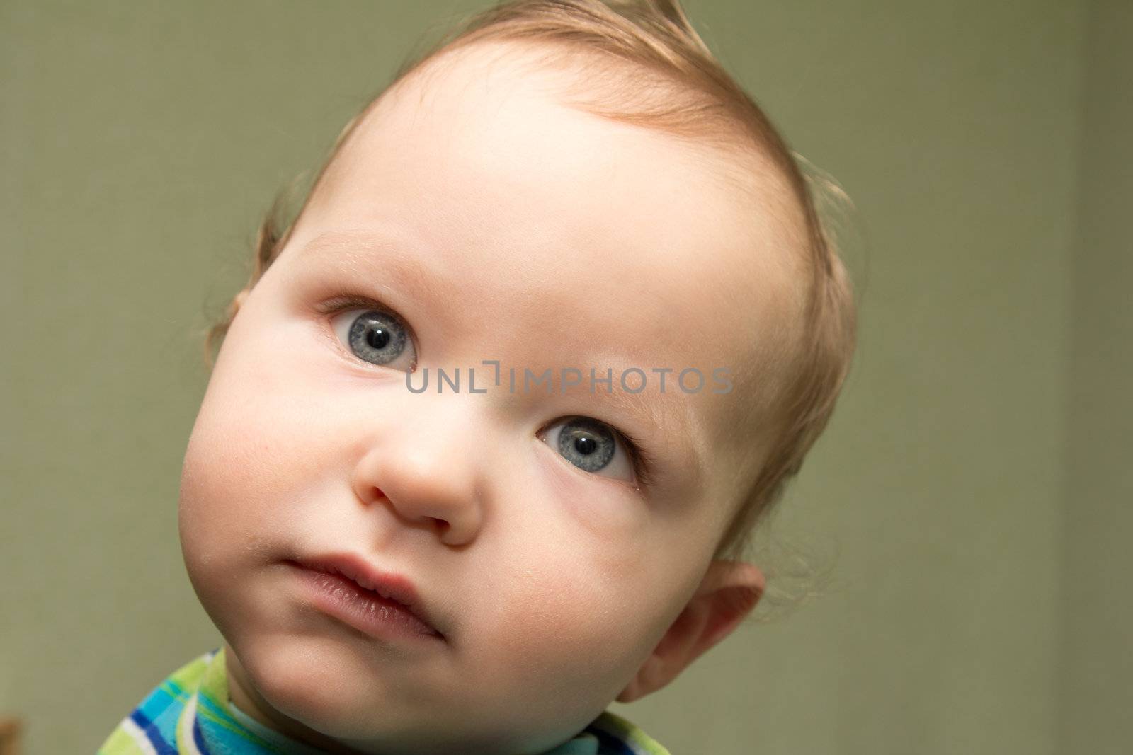 baby boy portrait on a green background
