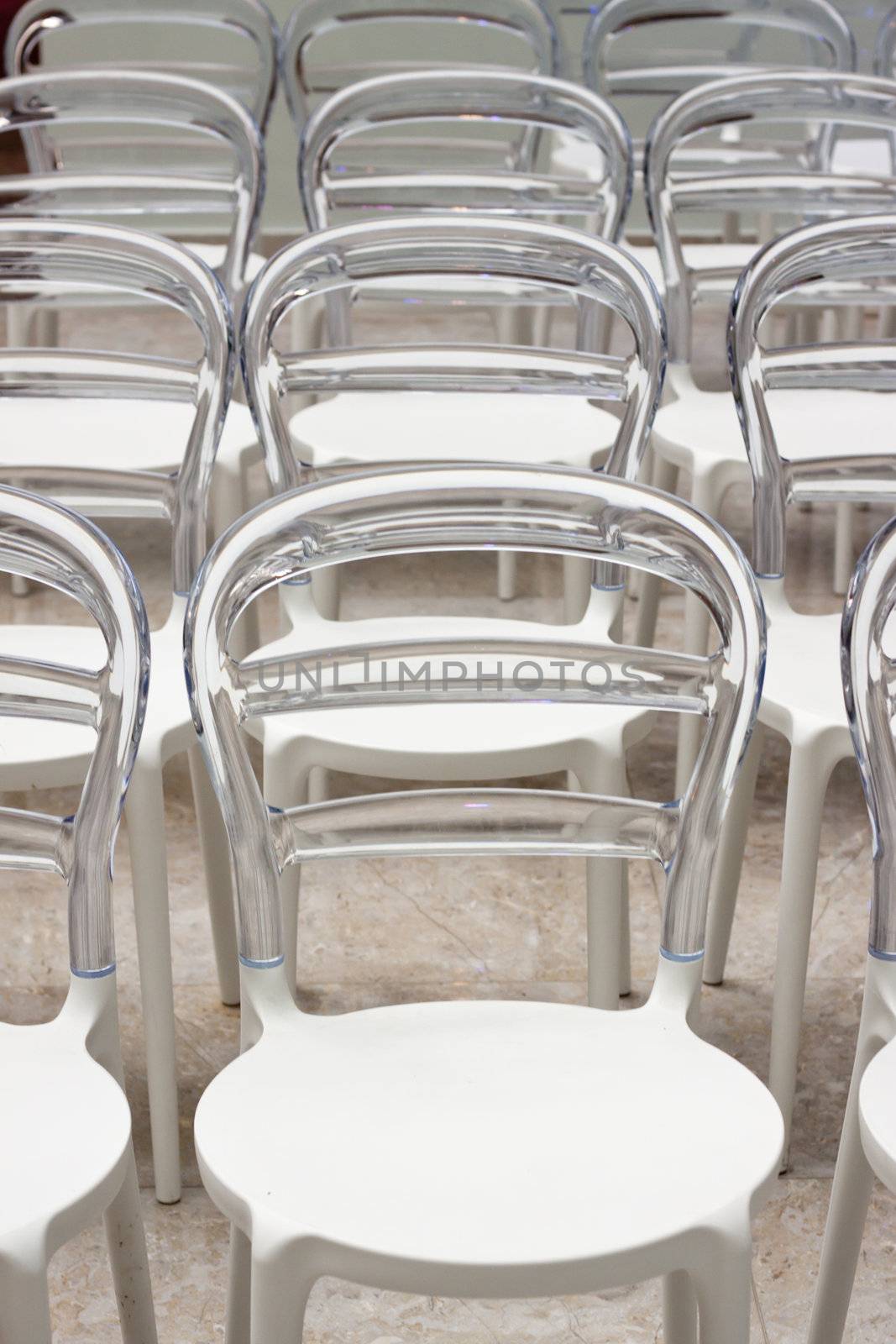 Row of plastic chairs by annems