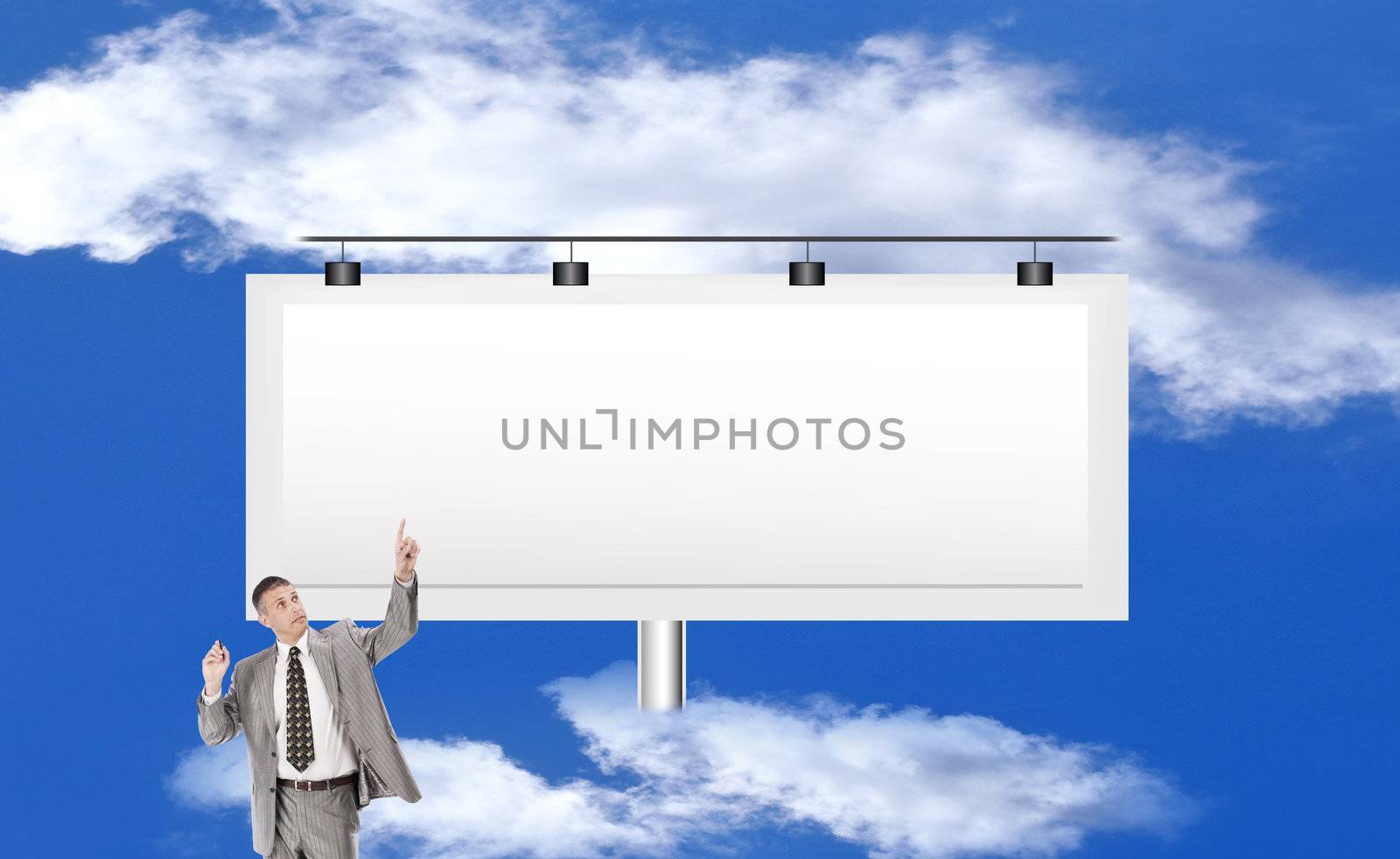 The successful businessman against a publicity board and the bright blue cloudy sky