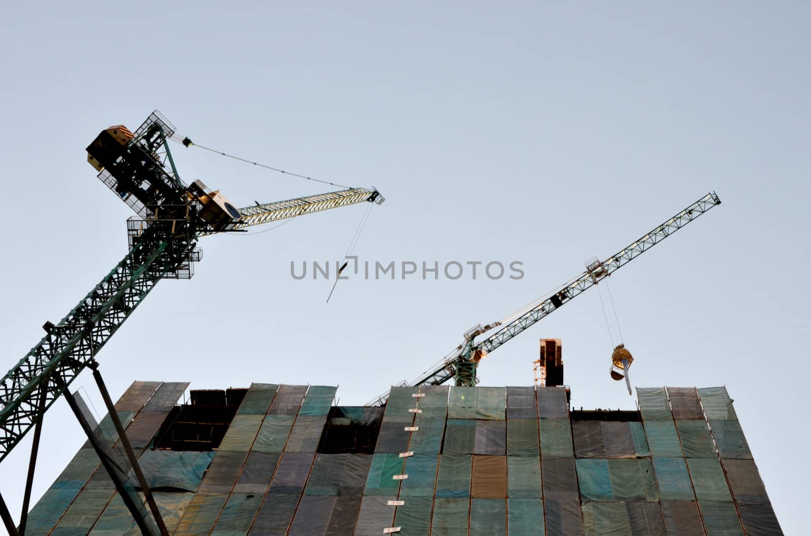 Crane in construction site and building by pixbox77