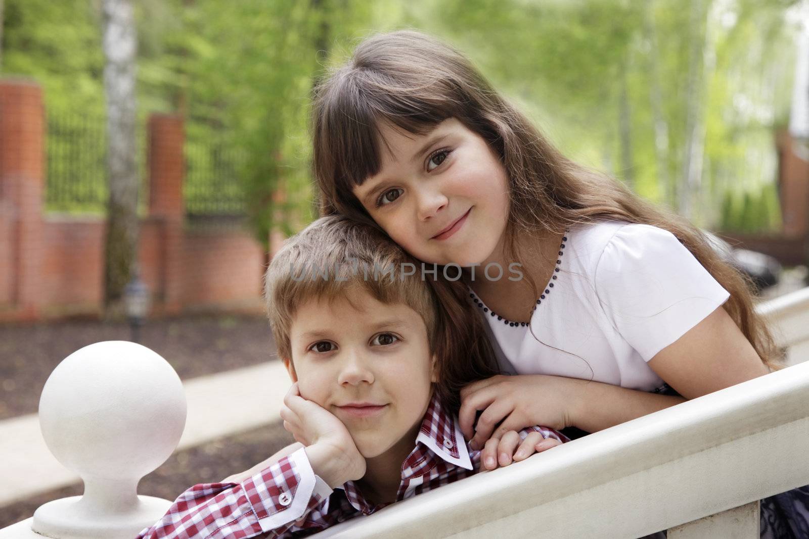 Brother and sister outdoors smiling