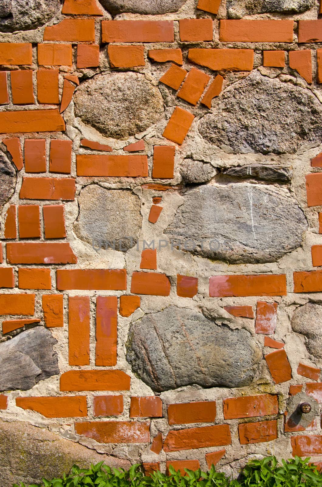 Big stones in red brick wall. Architecture closeup background details.